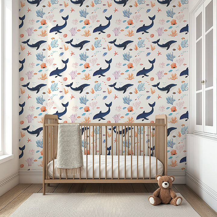 Dreamy coastal nursery with "Whale of a Time" wallpaper featuring whimsical whales, coral, and seaweed. Perfect for ocean-themed rooms.