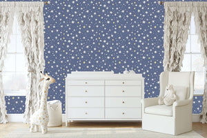 Children's room with Twinkle Twinkle Little Star wallpaper featuring playful stars, a giraffe plush, and cozy white furniture.