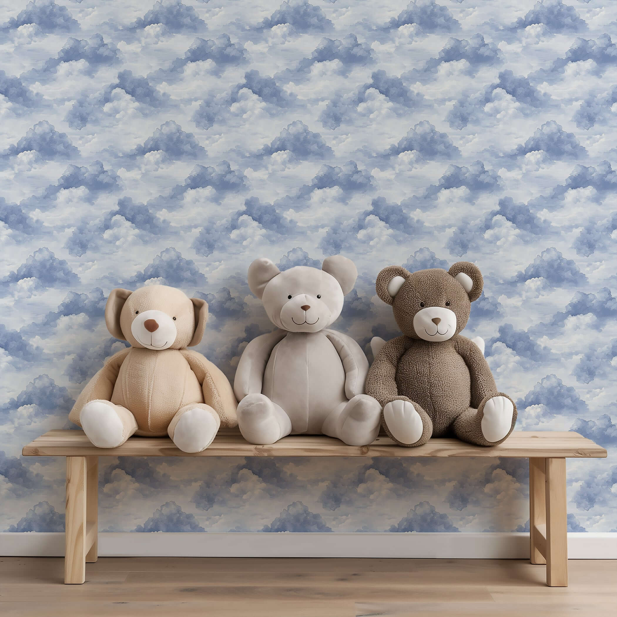 Cozy nursery with blue cloud wallpaper and three plush bears on a wooden bench, ideal for children's playroom décor.
