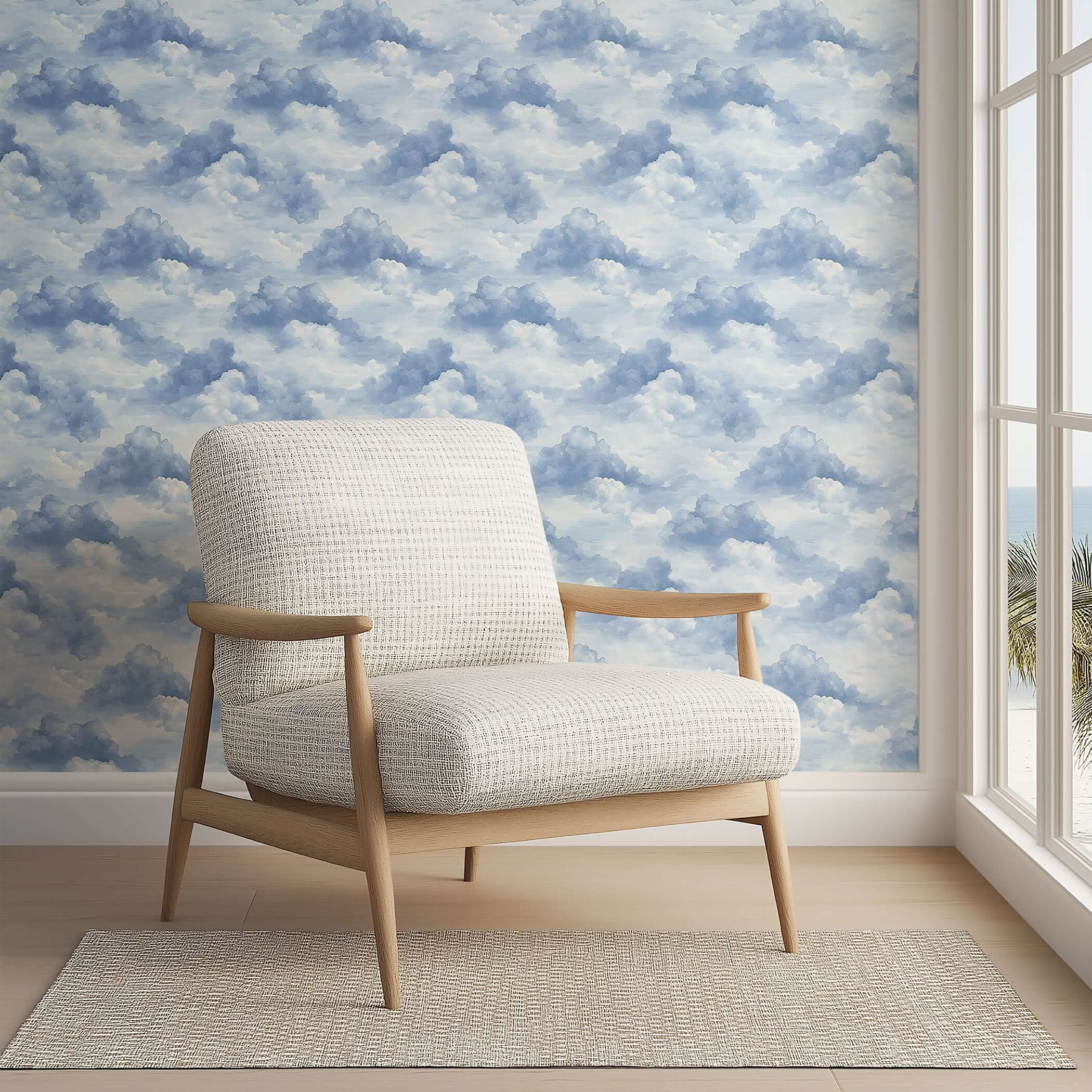 Cozy chair in front of Serene Cloud Drift Wallpaper, perfect for nurseries and playrooms with a soothing sky theme.