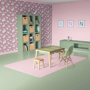 Cozy Cottontail Bliss wallpaper with playful bunnies on a mauve-pink background in a cute children's nursery and playroom setup.