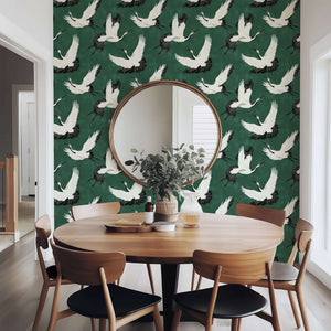 "Flight of the Cranes" wallpaper with white cranes on green backdrop, featuring classic and contemporary design in a dining room.