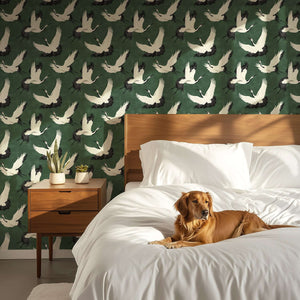Elegant Flight of the Cranes wallpaper with white birds on green, creating a contemporary and classic design in a cozy bedroom.