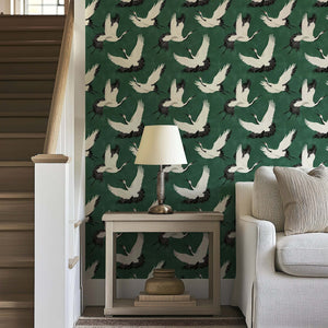 "Flight of the Cranes" wallpaper showcasing white cranes on a green background; perfect for classic or contemporary decor.