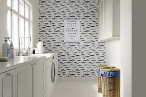 Vintage Fisherman wallpaper featuring hand-drawn fish illustrations in a coastal laundry room, enhancing oceanic charm and sophistication.