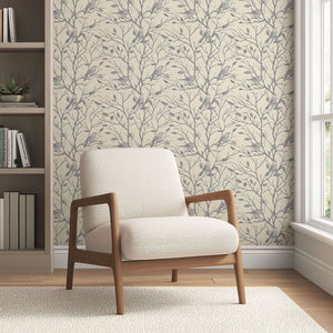 Monochromatic songbird silhouette wallpaper in a cozy room with a beige armchair, creating a serene forest atmosphere.