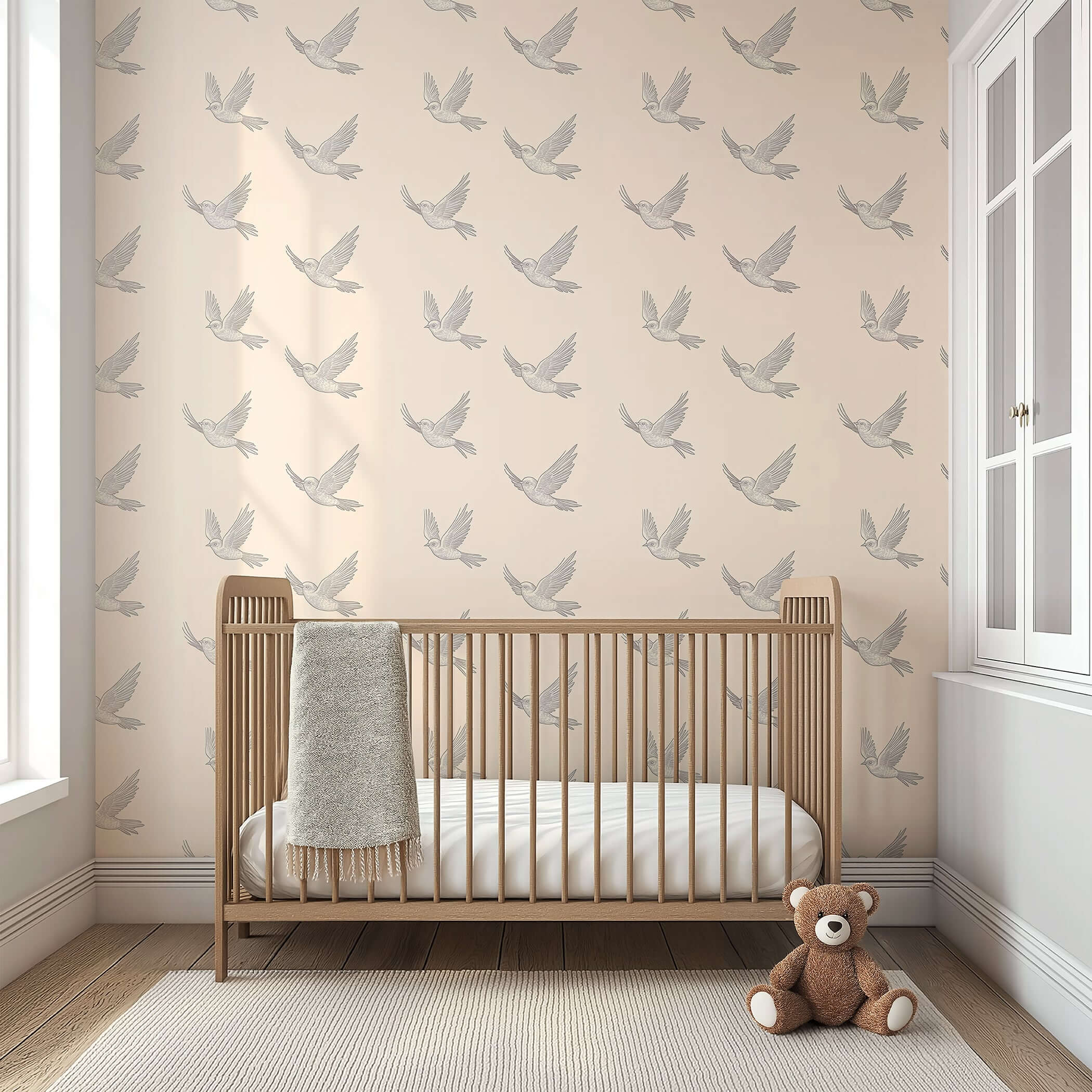 Modern nursery with 'Graceful Flight' monochrome bird wallpaper, wooden crib, and teddy bear.