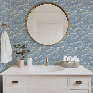 Coastal bathroom with Ocean Serenity wallpaper featuring wave designs in blue, enhancing maritime tranquility and coastal decor.
