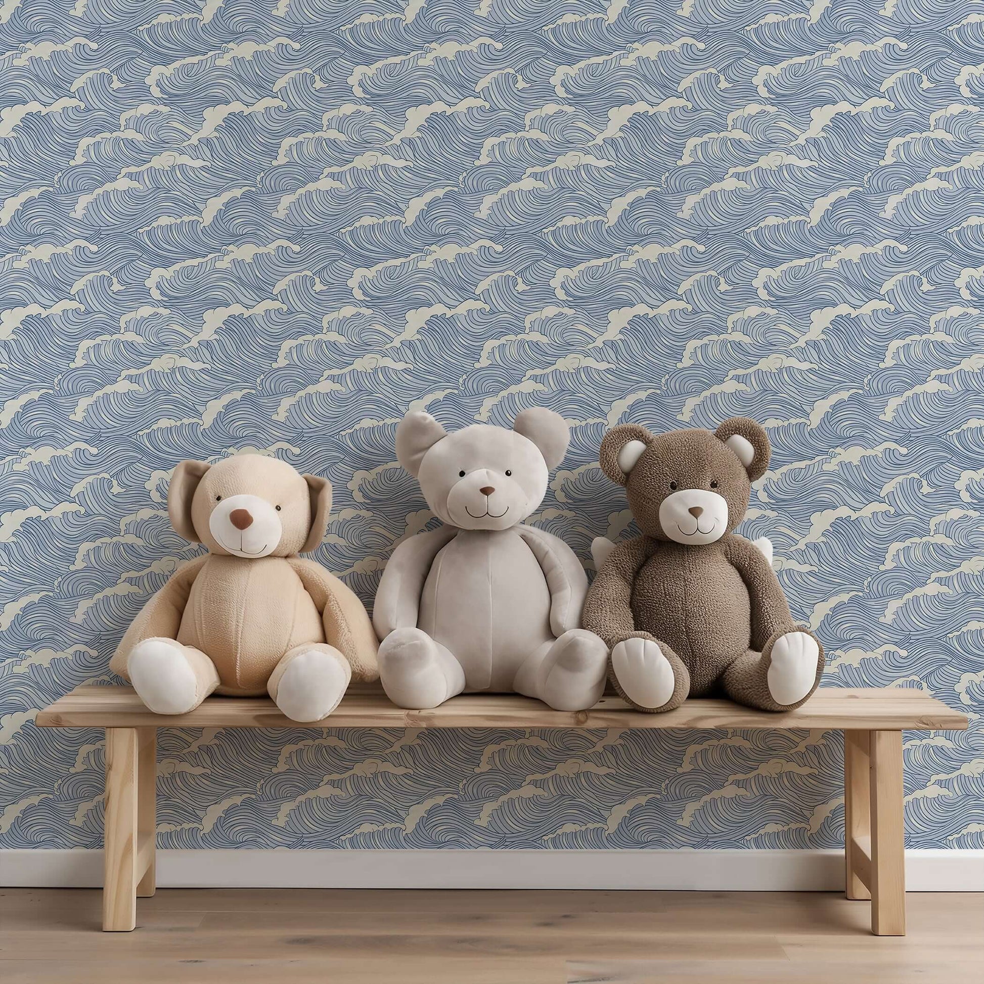 Coastal-themed nursery with Ocean Serenity wallpaper featuring wave patterns, behind a bench with three plush teddy bears, maritime ambiance.