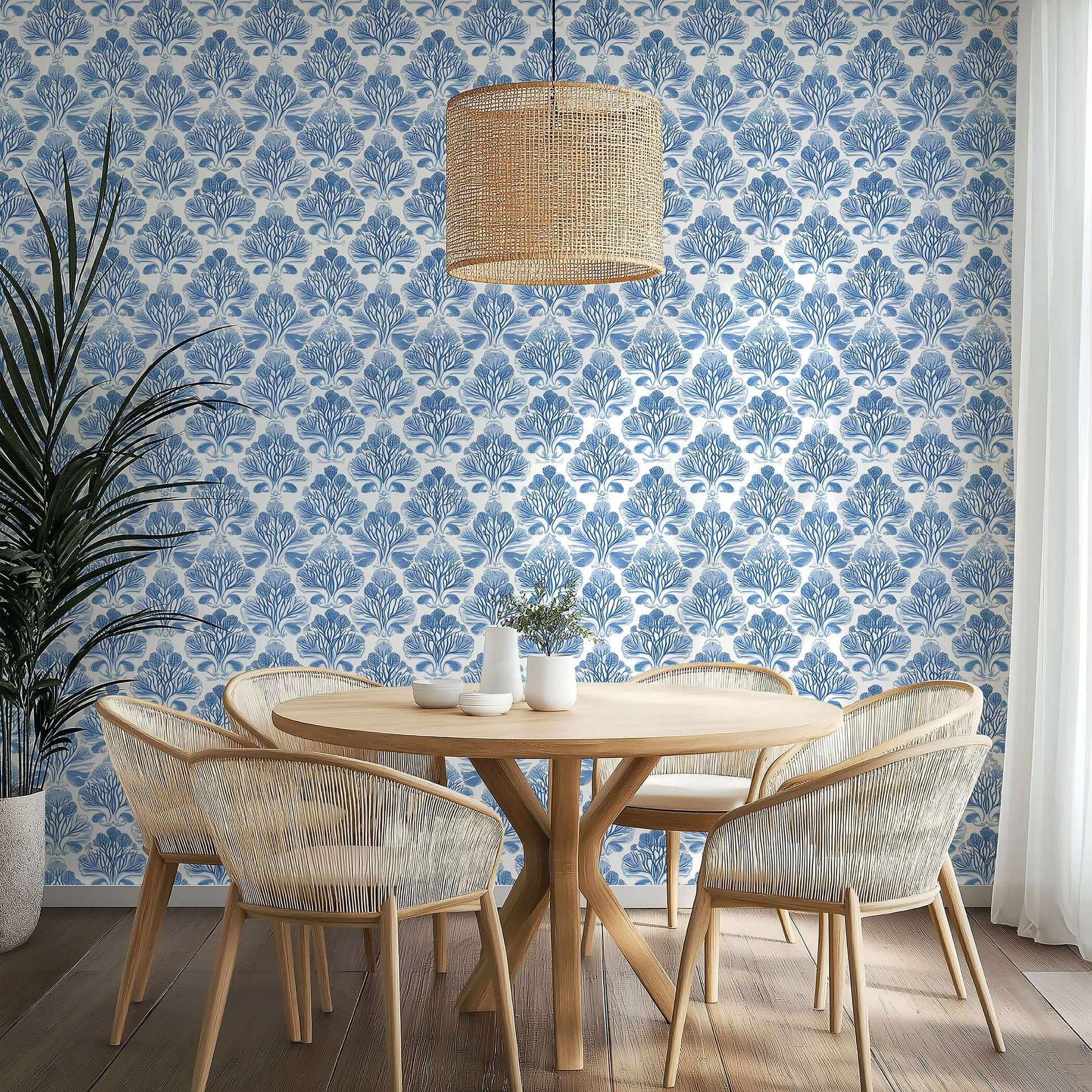 Dining area with Coastal Luxe Coral wallpaper, featuring blue coral reef silhouettes in a damask pattern. Coastal, ocean-inspired decor.