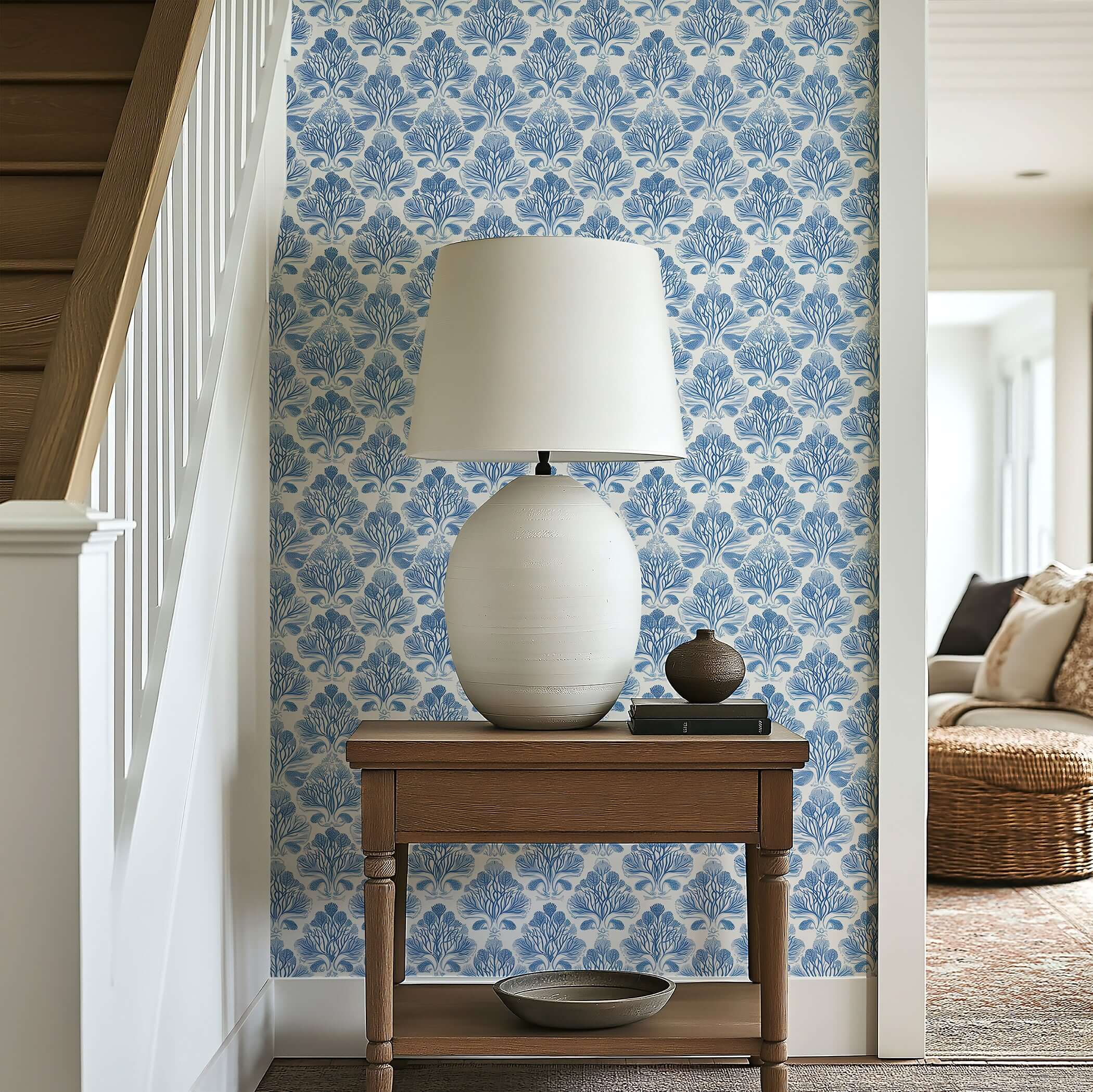 Coastal Luxe Coral wallpaper with blue coral damask pattern, enhancing an ocean-inspired aesthetic in a serene interior hallway.