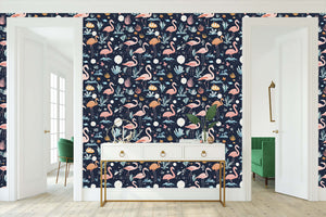 Navy coastal wallpaper with flamingos in moonlit lagoon, perfect for children's playroom; tropical plants enhance dreamy atmosphere.