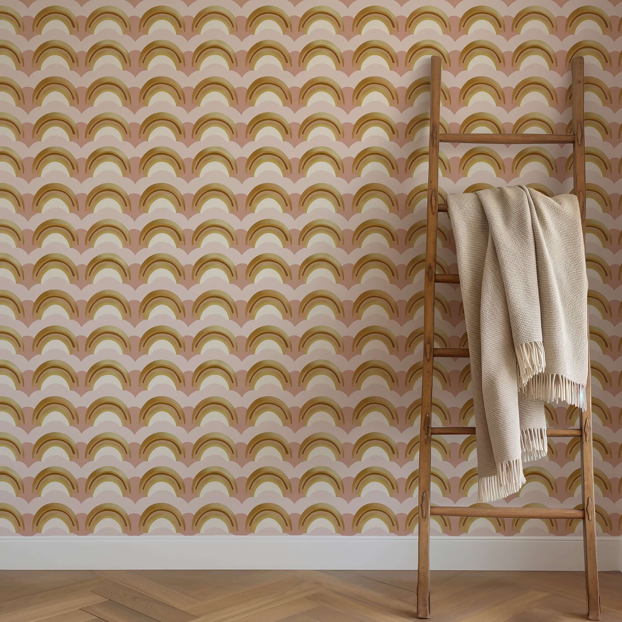 Golden Dream Rainbows wallpaper with gold arches on blush pink for nurseries, kids' rooms, and playrooms. Perfect for a whimsical touch.