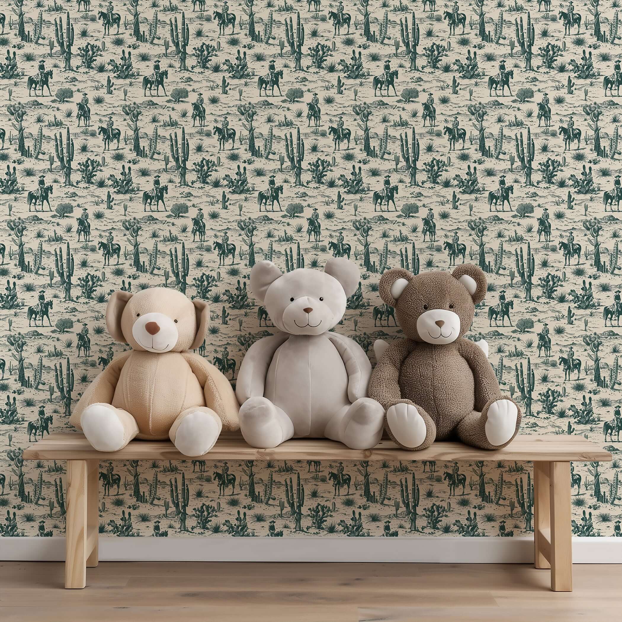 Western-style toile wallpaper with cowboys and cacti behind teddy bears on a bench, creating a rustic desert-themed setting.