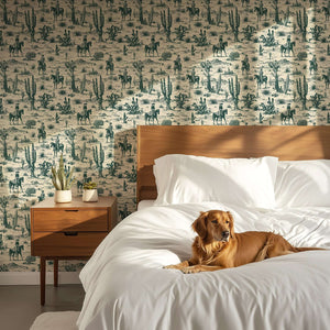 Western-themed toile wallpaper featuring cowboys, horses, and cacti in a desert setting, enhancing rustic home decor elegance.