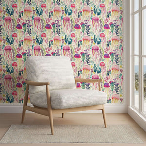 Enchanted Jelly Blooms wallpaper featuring colorful jellyfish and sea flora, creating a whimsical coastal atmosphere in a room.