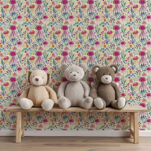 Ocean-inspired jellyfish wallpaper with vibrant magenta, teal, violet, and gold hues, accented by three plush teddy bears on a bench.