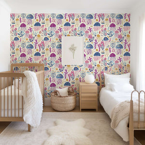 Jelly Drifts wallpaper featuring colorful jellyfish and sea plants in a cozy nursery setting, perfect for baby and children's rooms.