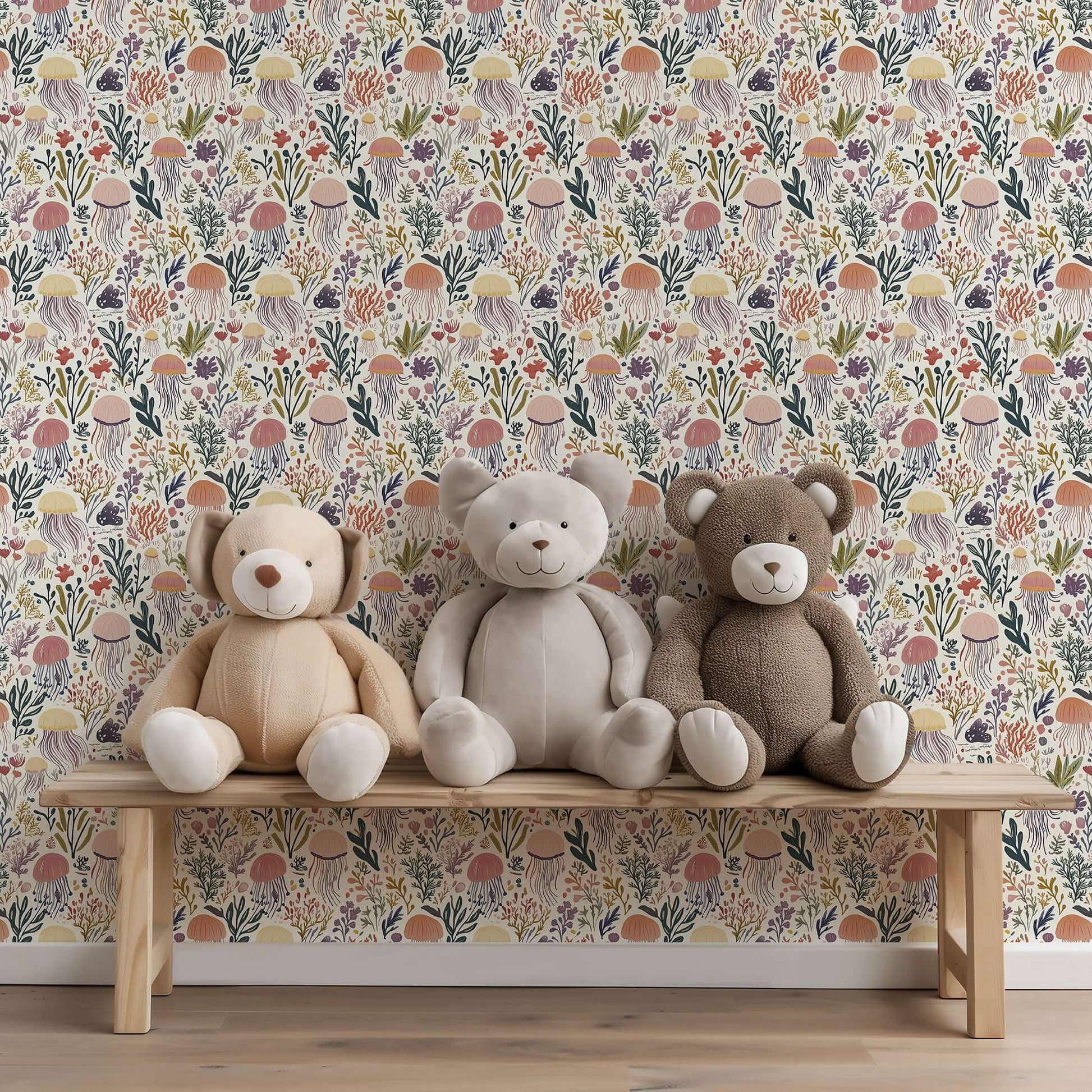 Teddy bears on a bench with Coral and Current jellyfish wallpaper, perfect for nurseries and playrooms.