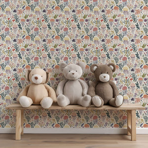 Teddy bears on a bench with Coral and Current jellyfish wallpaper, perfect for nurseries and playrooms.