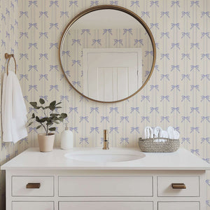 Vintage-inspired wallpaper with lavender ribbons and bows adds elegance to a powder room. Perfect for nurseries and shabby chic designs.