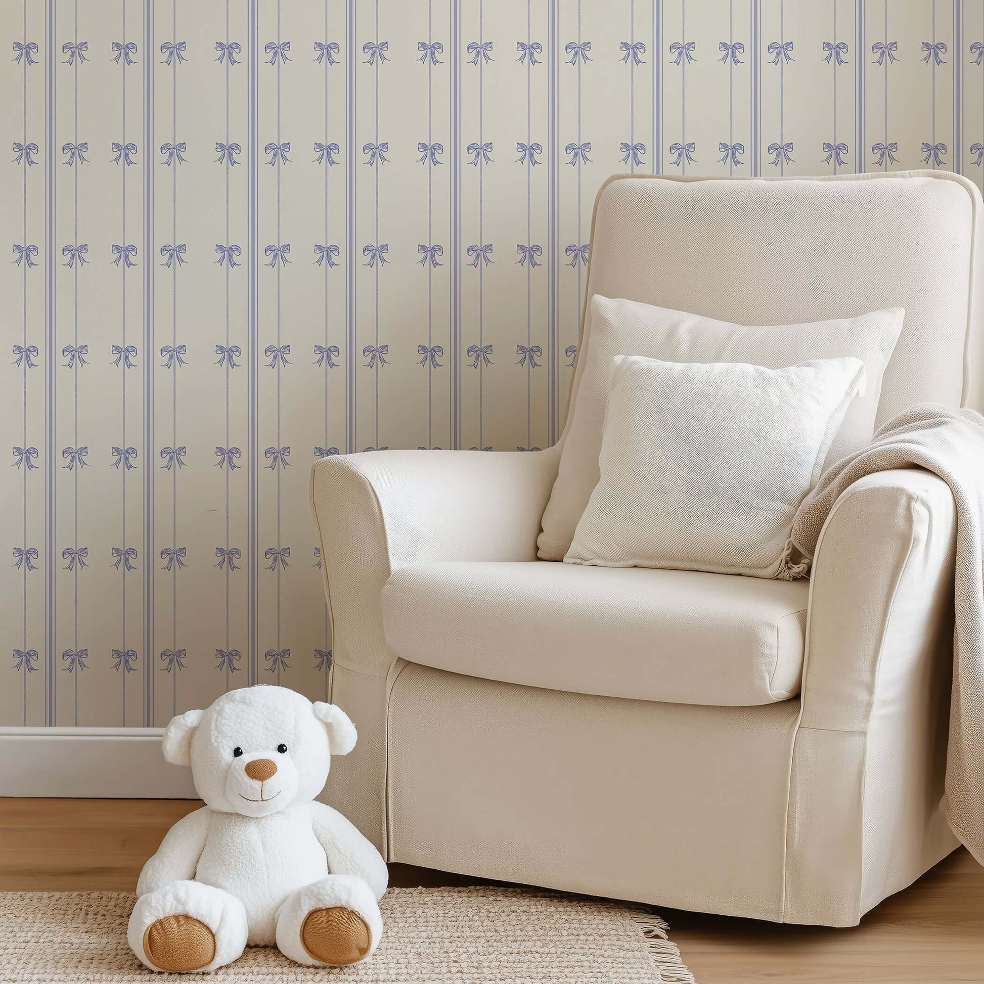 Charmed Bows Wallpaper with lavender ribbons in a nursery, featuring a cozy armchair and teddy bear for a charming, elegant setting.