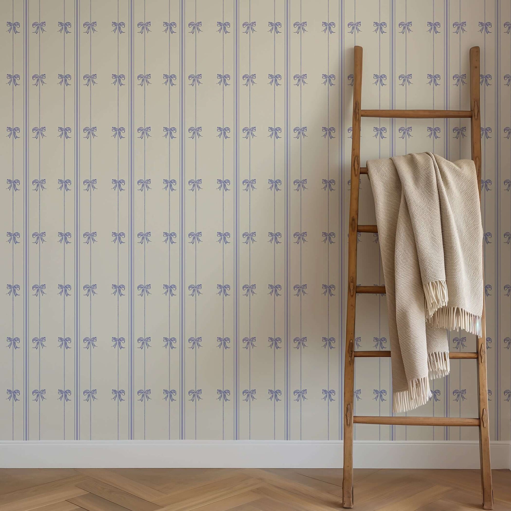 "Charmed Bows" wallpaper with lavender ribbons and blue bows, perfect for adding elegance to nursery or playroom walls.