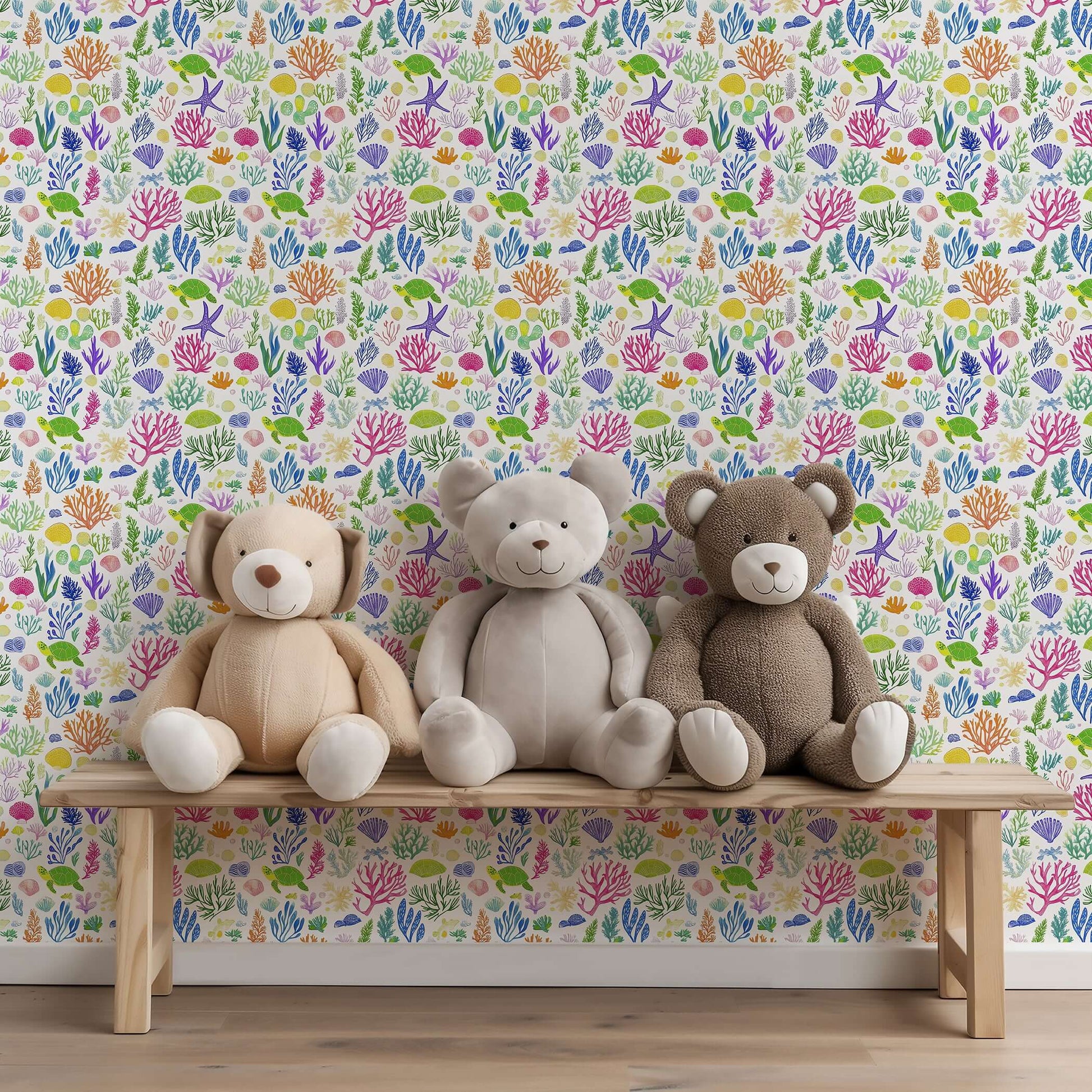 Ocean Safari wallpaper with colorful sea creatures, fish, and seaweed behind teddy bears on a bench in a nursery setting.