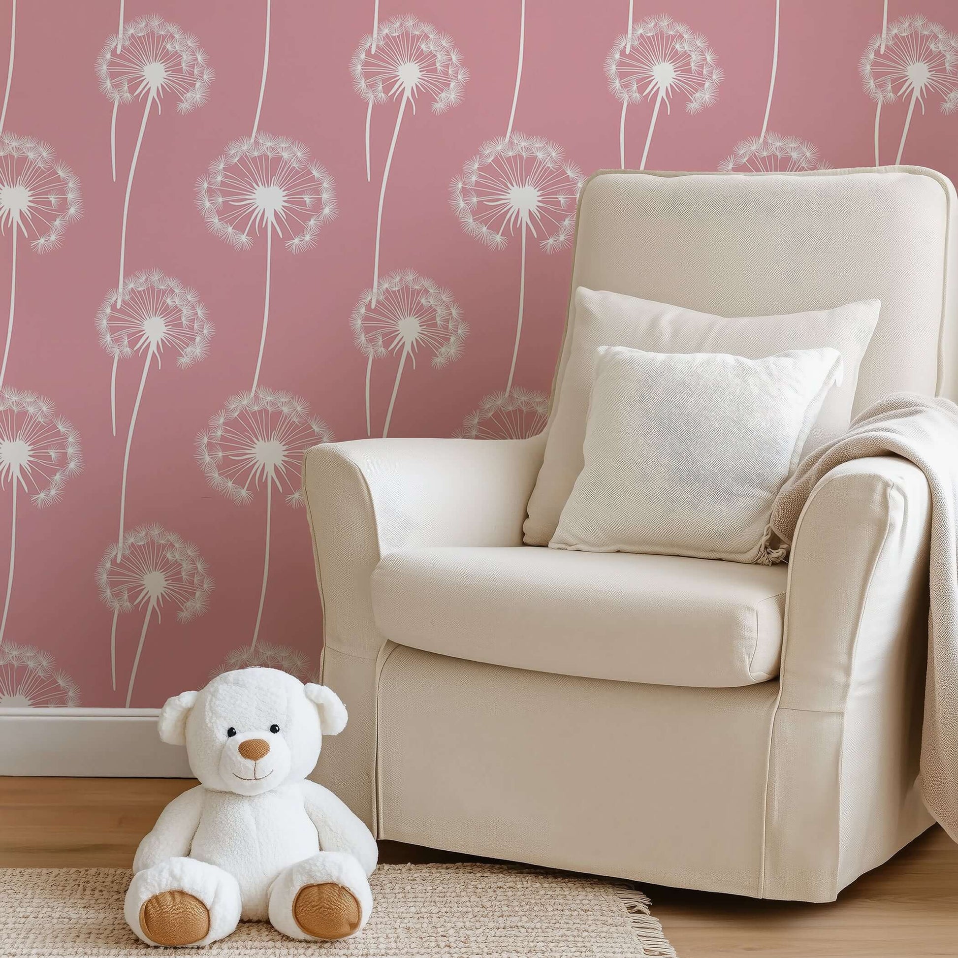 Pink wallpaper with white dandelions in a nursery setting with a plush bear and comfy chair, ideal for children's rooms and playrooms.
