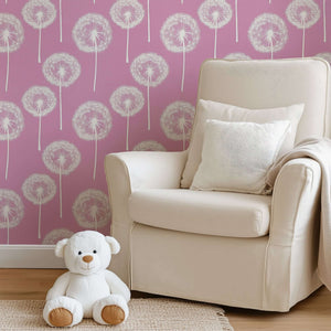 Pink Puff Paradise wallpaper with white dandelions on rose-pink, featuring a cozy nursery scene with teddy bear and plush chair.
