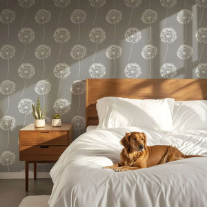 Bedroom with gray dandelion wallpaper, white bedding, wooden furniture, and a dog lounging on the bed. Ideal for children's nursery.