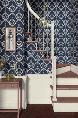 Vintage Crest Wallpaper with ivory crests and laurel wreaths on a dark navy background, enhancing a staircase area.