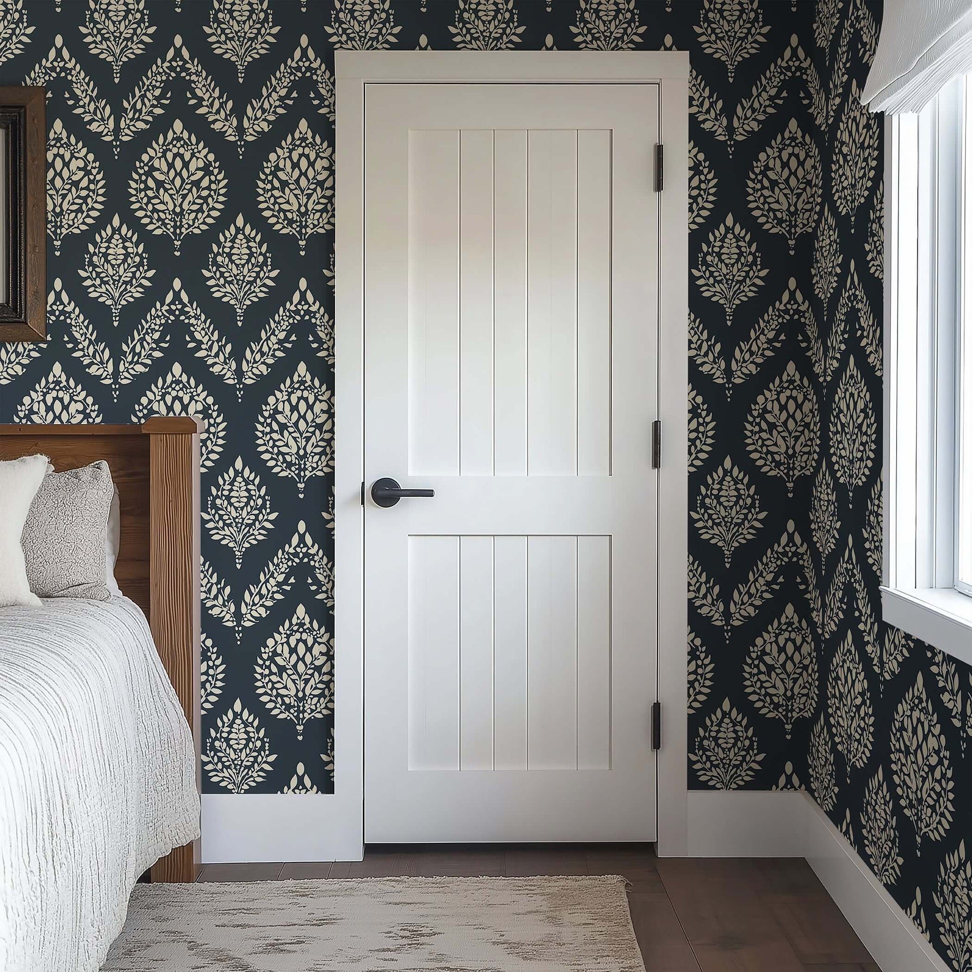 Heritage Flora wallpaper with ivory botanical pattern on charcoal, featuring laurels, adding elegance to a bedroom with white door.