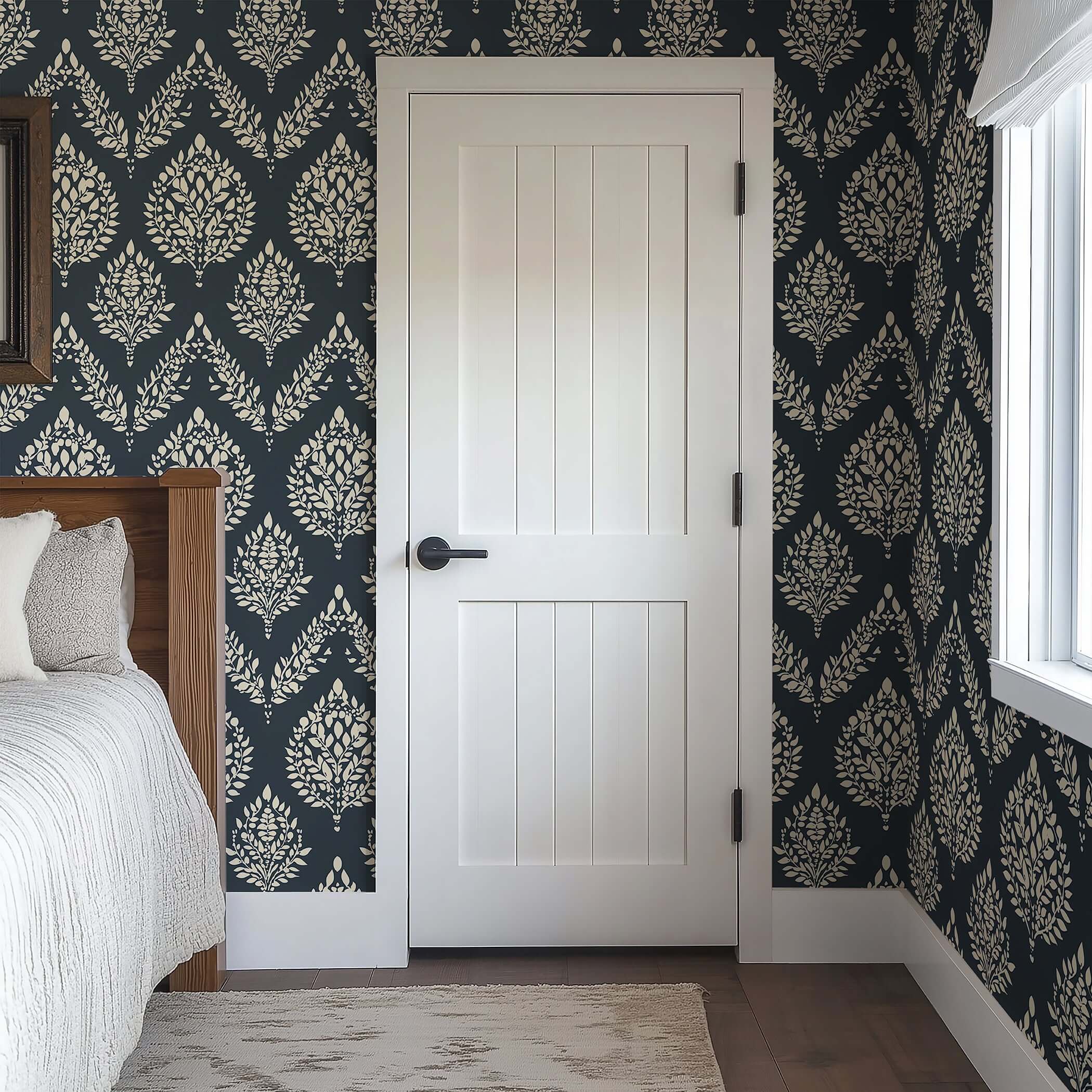 Heritage Flora wallpaper with ivory botanical pattern on charcoal, featuring laurels, adding elegance to a bedroom with white door.
