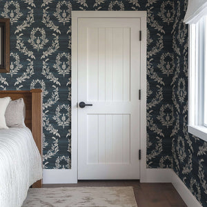 Room with Midnight Laurel wallpaper featuring white laurel wreaths on dark blue, adding vintage elegance to traditional decor.
