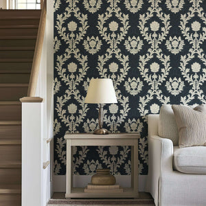 Regal Midnight Flourish wallpaper with ivory damask florals on a dark background, enhancing vintage decor in a living room.
