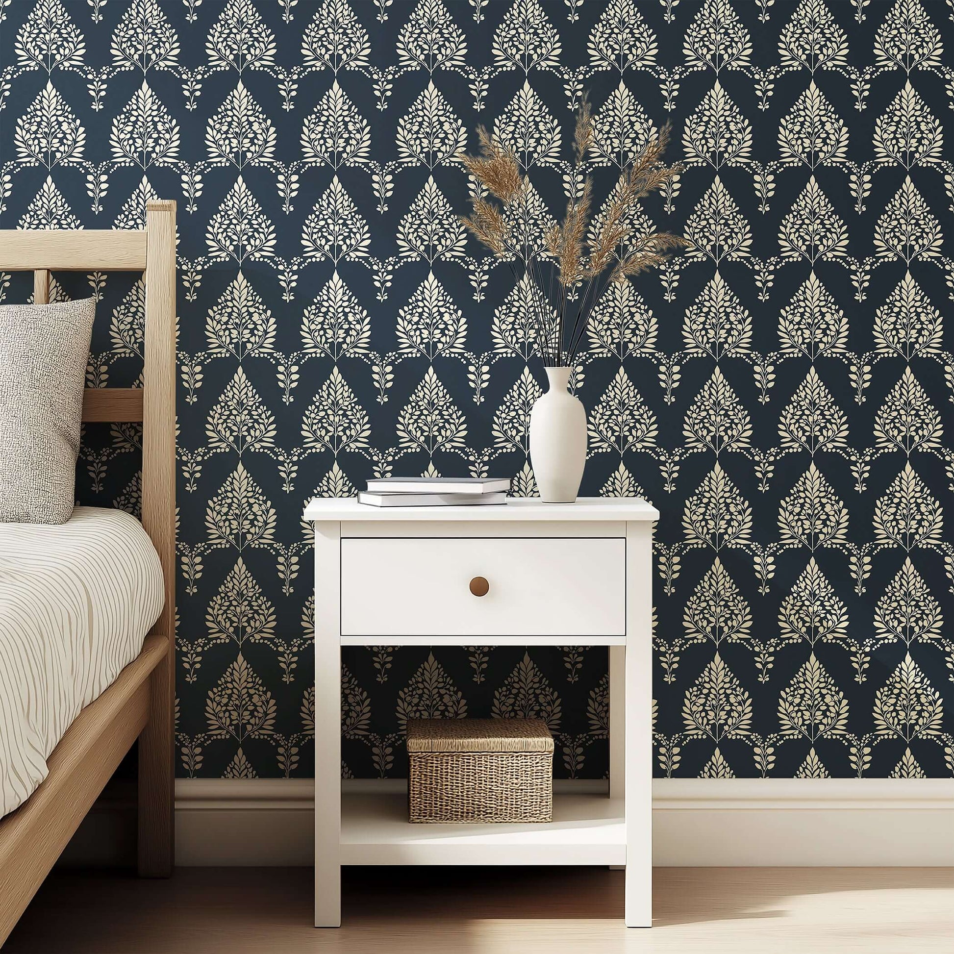Noir Bloom wallpaper with creamy floral and laurel wreath silhouettes against a charcoal background in a bedroom setting.