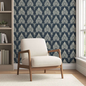 "Noir Bloom" wallpaper featuring creamy floral and laurel silhouettes on charcoal, perfect for elegant home decor.