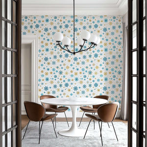 Mid-century modern dining room with "Golden Snowfall" wallpaper featuring gold and blue snowflakes, enhancing holiday decor.