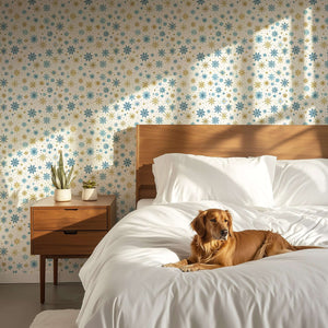 Mid-century modern bedroom with Golden Snowfall wallpaper, featuring gold and blue snowflakes, enhancing a cozy, festive ambiance.