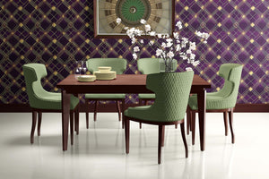 Art Deco dining room with Deco Diamond Noir wallpaper showcasing geometric patterns in plum and gold, green chairs, and wooden table.
