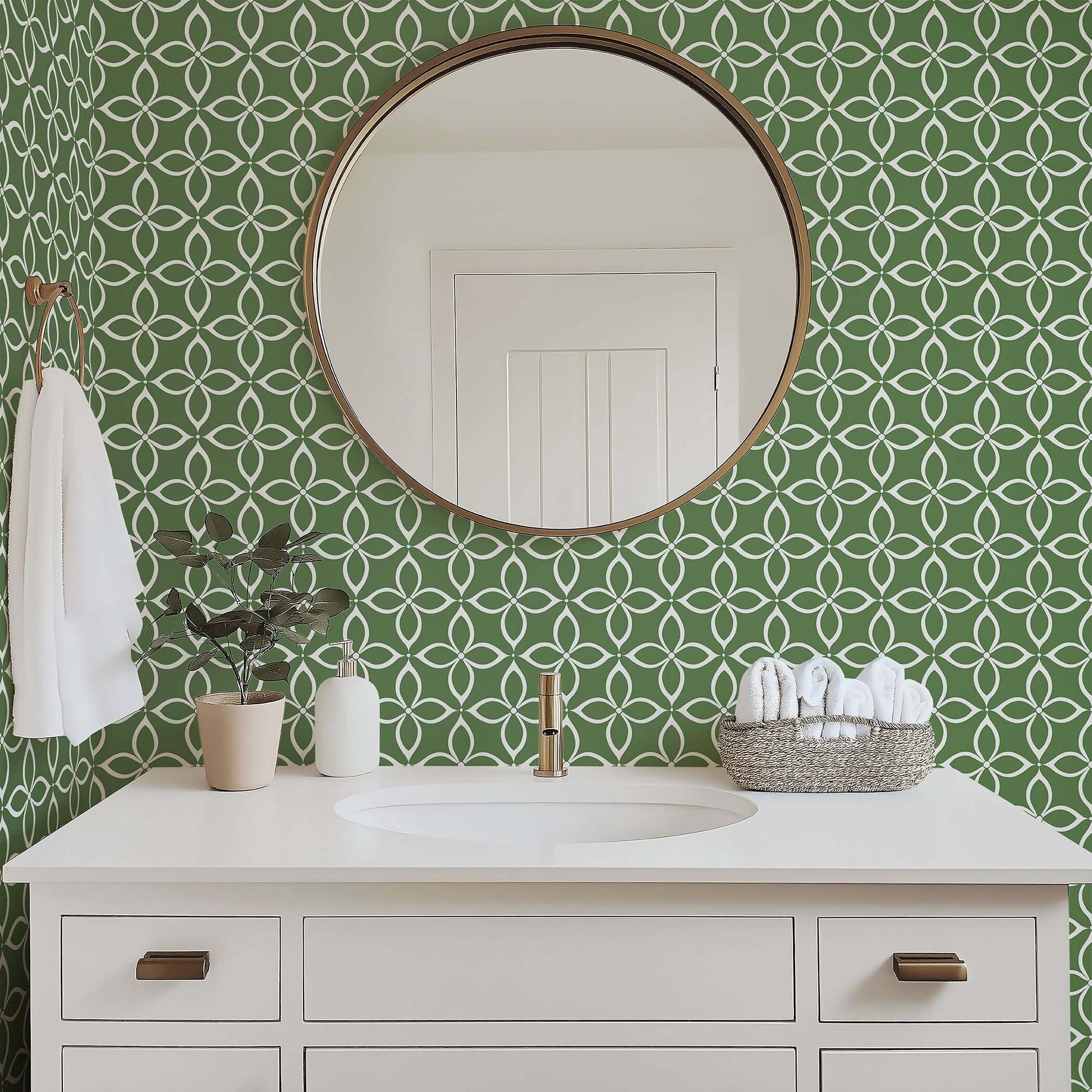 Modern bathroom with Verdant Minimalism wallpaper featuring geometric flower patterns in white on sage green behind a sleek vanity.