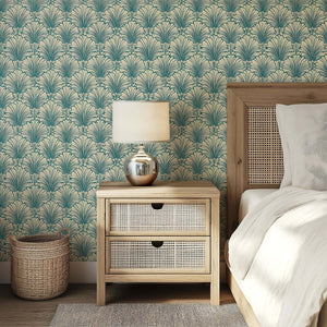 Art Deco teal and tan fan motif wallpaper in a stylish bedroom setting, evoking coastal luxury with a wooden nightstand and woven accents.