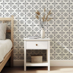 Gothic Revival geometric wallpaper with black, ivory, and violet tile patterns in a bedroom setting, offering a sophisticated look.