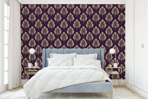 Golden Luxe Leaf wallpaper with Art Nouveau floral design, featuring gold leaves on a plum background, enhancing modern bedroom decor.