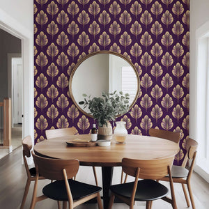 Golden Luxe Leaf Art Deco wallpaper with gold leaves on plum background enhances dining room, exemplifying modern floral design.