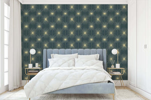 Celestial Gold Sparkle wallpaper in bedroom with mid-century modern decor, featuring golden starbursts on teal-blue background.