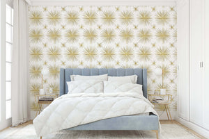 Vintage Gold Star Wallpaper featuring a mid-century modern retro gold starburst pattern on a white background in a stylish bedroom.
