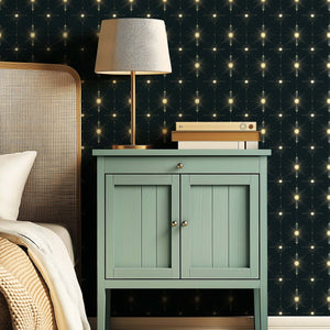 Art Deco Starlight Symphony wallpaper with starburst motifs in soft gold and midnight tones, enhancing a stylish modern bedroom.