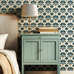 Art Nouveau styled Elysian Green wallpaper with floral design in a bedroom setting, featuring a green nightstand and a table lamp.